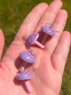 These purple and pink mushrooms are handmade from polymer clay and hand painted. Each mushroom is sculpted by hand individually, so some may vary slightly due to the nature of how they are made. However, they're all made with the same shape in mind!  Hardware is hypoallergenic for sensitive skin. Perfect for springtime and summer! 🌸 Cute Handmade Mushroom-shaped Earrings, Cute Handmade Mushroom Earrings, Handmade Cute Mushroom Earrings, Whimsical Pink Polymer Clay Earrings, Pink Mushroom Jewelry For Gifts, Mushroom Clay, Pink Mushrooms, Clay Mushroom, Pink Mushroom