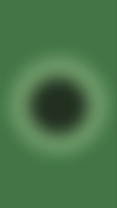 an image of a black hole in the middle of green wallpaper that appears to be dark