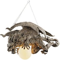 a light fixture made out of wood with chains hanging from it's sides and an egg in the center