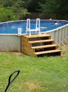 an above ground swimming pool with steps leading up to the deck and ladders on top