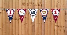 an american flag banner hanging on a wooden fence with the word i am in red, white and blue