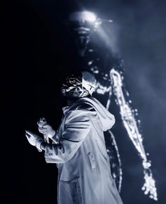 a man standing in front of a projection screen holding his hands out to the side