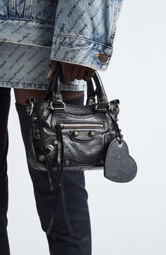 Balenciaga reimagines an '00s style with this spacious tote crafted from richly crinkled metallic leather and detailed with textured hardware. A tasseled zipper pull and heart-shaped mirror bag charm complete the look with signature flair. Top zip closure Top carry handles; removable, adjustable shoulder strap Exterior front zip pocket Structured silhouette with flat base for stability Cotton-canvas lining Leather Made in Italy Designer Handbags Balenciaga Mini City Bag Outfit, Balenciaga Bag City, Balenciaga Bag Outfit, Balenciaga Mini City Bag, Balenciaga Mini City, Mirror Bag, Shoulder Bag Outfit, 00s Style, Dream Bag