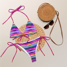 Stay comfortable and stylish all summer with this All-Over Print Recycled String Bikini set. It’s made from soft recycled polyester with double-layering and UPF 50+. Style the straps how you like, and get ready to swim! • Soft and stretchy material with UPF 50+ • Sizes up to 6XL • Bikini top comes with removable padding for comfort • Multiple ways to tie and style the bikini set • Color design options for swimwear lining Disclaimers: • Due to the 2-layered construction and internal stitching, a Multicolor String Swimwear For Poolside, Adjustable Multicolor Tie-side Swimwear Bottom, Adjustable Multicolor Tie-side Swimwear, Summer String Swimwear For Swimming, String Swimwear For Summer Swimming, Multicolor Adjustable Swimwear For Poolside, Adjustable Multicolor Swimwear For Sunbathing, Adjustable Multicolor Swimwear For Poolside, String Swimwear For Beach Season Vacation