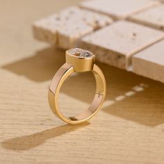 a gold ring sitting on top of a wooden table