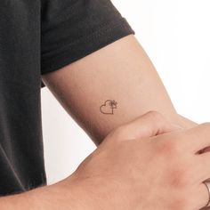 a person with a small tattoo on their arm