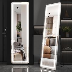 two large mirrors with lights on them in the middle of a room, one is illuminated and the other has a couch