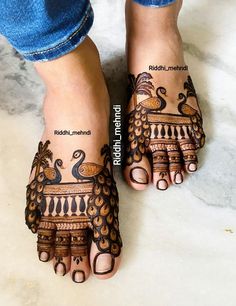 feet with henna tattoos on them