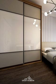 an image of a bedroom setting with sliding closet doors and lights on the ceiling above the bed