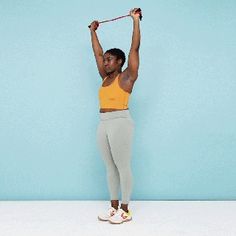 a woman is doing exercises with a resistance band