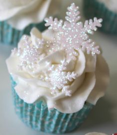 cupcakes decorated with white frosting and snowflakes