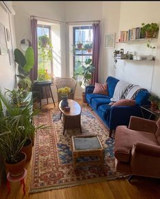 a living room filled with furniture and plants