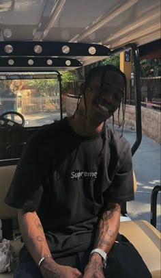 a man sitting in the back of a golf cart with his arm wrapped around him