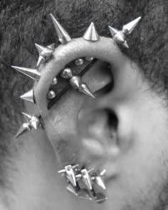 a man with spiked nose piercings on his ear