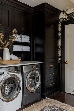 a washer and dryer in a room with dark wood paneling on the walls