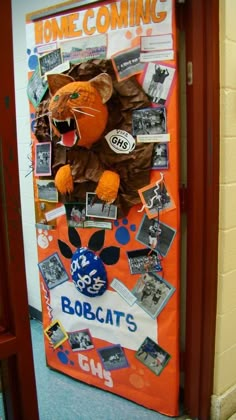 a door decorated with an orange cat and some pictures on the front, along with other decorations