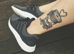 a woman's leg with a tattoo on it that has a barrel and flowers