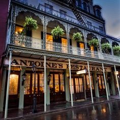 an old - fashioned restaurant is lit up at night in new orleans, florida usa