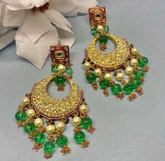 Indian Jewelry are always a part of all the Indian celebration around the globe . One definitely complete her look once they own it . This Chandbali kundan  earrings are plated in gold plating for longer lasting. This Chandbali Earrings looks beautiful  and elegant perfect for all occasion on any outfits you choose to wear (saree, salwar suits, lenga, etc.) *High quality craftsmanship 100% satisfaction guarantee  *Plated in  Gold plating *Earring Closure push back *base metal for earring is brss * Earring length 11cm *package include Chandbali earrings  *ready to ship from Houston TX United States GIFT- It comes in gift box perfect for gifting to your mom , sister, in laws, friends, on there birthday, wedding , bridal shower, anniversary, festival , and many more... Discover a variety of N Green Chandbali Pearl Earrings For Celebration, Traditional Green Bridal Earrings For Anniversary, Traditional Handmade Bridal Earrings For Anniversary, Traditional Green Earrings For Wedding, Handmade Traditional Bridal Earrings For Anniversary, Traditional Green Round Pearl Earrings, Traditional Green Pearl Earrings For Celebrations, Traditional Green Wedding Earrings, Traditional Pearl Earrings For Anniversary