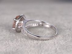 two wedding rings sitting on top of a white carpeted floor next to each other