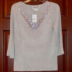 Joseph A. V Neck Gray Sweater With Silver Flecks * Clear Stone Trim * 3/4 Sleeve * New * Size Large * 57% Viscose * 23% Nylon * 20% Metallic * Armpit To Armpit Is 22 In * Neck To Hem Is 23 In * Fro My Smoke Free Home * Thank You For Browsing My Closet * Box #14-3 Gray V-neck Top For Winter, Chic Silver V-neck Top, Gray V-neck Tops With Button Closure, Gray Knit V-neck Outerwear, Luxury Gray V-neck Sweater, Gray Sweater, Clear Stone, Grey Sweater, New Color