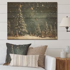 a living room with a white couch and christmas tree painting on the wall above it