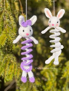 two crocheted bunnies hanging from a tree with the words bunny and rabbit on them