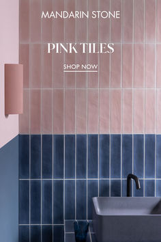 a bathroom with blue and pink tiles on the wall