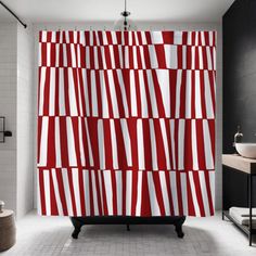 a red and white shower curtain in a bathroom