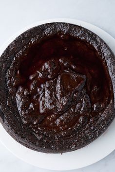 a chocolate cake sitting on top of a white plate