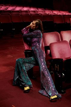 a woman sitting on a chair in an auditorium