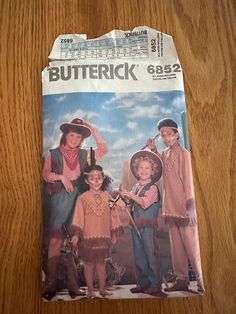 a paper bag with an image of two children in cowboy outfits on the front and back