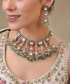 Gorgeous Sabyasachi inspired  Finest Quality Moissanite Kundan Polki Choker Necklace with matching earrings.  Tikka Can Be Purchased Additionally  Green stones are made of natural onyx and white tiny ones of high quality cubic zirconia. Metal:  Silver content around 20%.+ High Grade Sipver Alloys  22 Kt  gold and rhodium plated. This choker is flexible and takes the shape of the neck. Fine quality and craftsmanship. Perfect for desi weddings. Necklace comes in drawstring cord therefore adjustable Please let me know if you have any Questions .  This set will surely make heads turn .. Finest Kundan work . Customized orders takes 3 to 4 weeks, depending on piece requirements. The Ombre Designs Jewelry pieces can be customized in accordance with your requirement. Please Email or Whats app on : Indian Bridal Necklace, Polki Choker, Jewelry Pakistani, Kundan Jewelry, Green Stones, Pakistani Jewelry, Desi Wedding, Jewelry Indian, Necklace Wedding