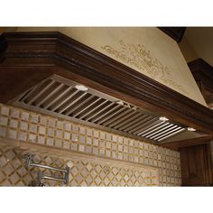 a kitchen hood with decorative tiles on it