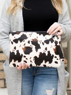 Introducing our new Spotted Cow Print Oversized Everyday Clutch! Stay on trend with this quirky and playful addition to your wardrobe. One zipper pocket and 2 open pockets for convenient storage. Keep your on-the-go essentials organized in this oversized clutch. Color: Black or Brown Made of: Soft Vegan Leather, 100% polyester full lining Includes: x1 Clutch, Attached Wristlet Size: 12" L x 8" W Vacation Outfit Ideas For Women, Cute Summer Outfits 2023, Oversized Clutch Bag, Perfectly Organized, Vacation Outfit Ideas, Women Summer Outfits, Oversized Clutch, Printed Clutch, Vacation Outfit