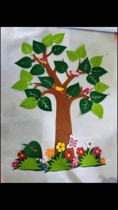 a paper cut out of a tree with leaves and flowers