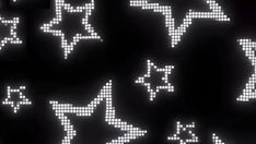 an array of pixelated stars and moon shapes in white on black with dark background