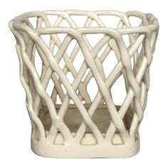 a white ceramic vase with wavy lines on it's sides and an opening at the top