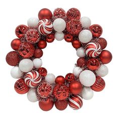 a wreath with red and white ornaments hanging from it's sides on a white background