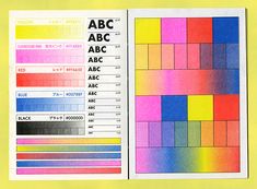 an open book with different colored squares and numbers on the pages, all in one color