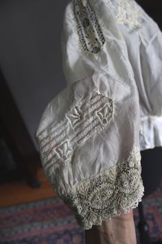 "Outstanding museum quality intricately embroidered antique silk blouse. Off white cream color. Very wearable size that fits up to 36\" bust. 3/4 loose fitting sleeves. Extensive cream color hand embroidery on bodice and sleeves. It is 14\" across waist when laying flat and 17\" long from mid shoulder to hem. Hooks and eyes for closure up the back. Small inset embroidered panel at front neckline in very pale pastel tones. So very beautiful and in fantastic shape. 1\" area along seem at waist tha Bohemian Chikankari Embroidery Wedding Blouse, Bohemian Blouse With Chikankari Embroidery For Wedding, Bohemian Wedding Blouse With Chikankari Embroidery, Vintage White Blouse With Intricate Embroidery, White Victorian Blouse For Wedding, Fitted Vintage Blouse With Intricate Embroidery, Vintage Fitted Blouse With Intricate Embroidery, Victorian Lace Work Blouse For Wedding, Vintage Wedding Blouse With Floral Embroidery