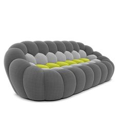 a gray and yellow couch sitting on top of a white floor