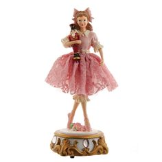 a figurine of a girl holding a nutcracker