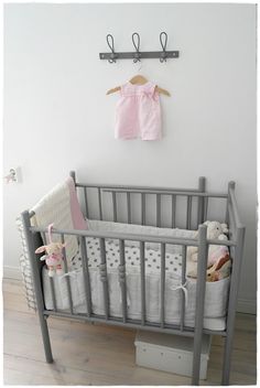 a baby's crib in the corner of a room