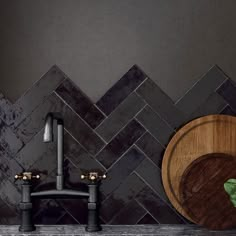 a wooden cutting board sitting on top of a counter next to a wall mounted faucet