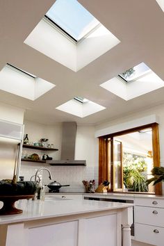 an open kitchen with skylights above the counter