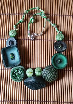 a necklace with green and black buttons on it