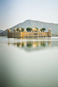 a large yellow building sitting on top of a lake