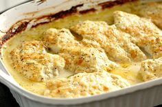 a casserole dish filled with chicken and cheese