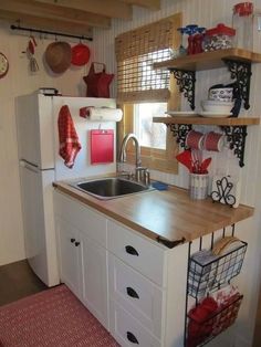 a kitchen with white cabinets and wooden counter tops